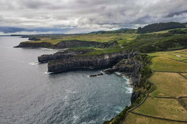 Aerial view of the dramatic coastal cliffs and lush landscapes of São Miguel Island, Azores.